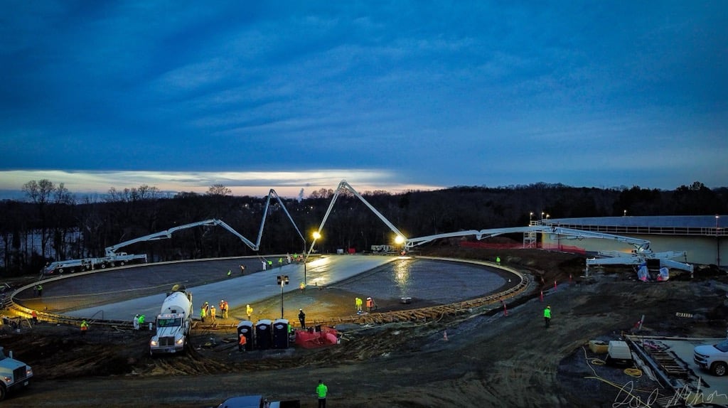 Concrete pump on job site at dusk